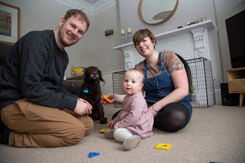 Stacy, daughter Elfie, partner and pet dog at home.